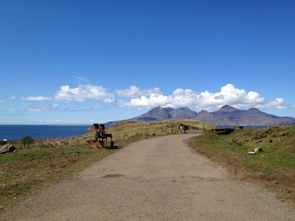 An open road under brilliant blue sky on the island of Eigg