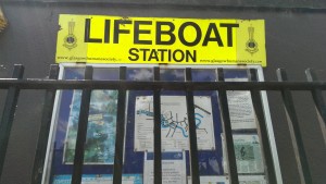 A yellow sign for the Lifeboat station on Glasgow Green