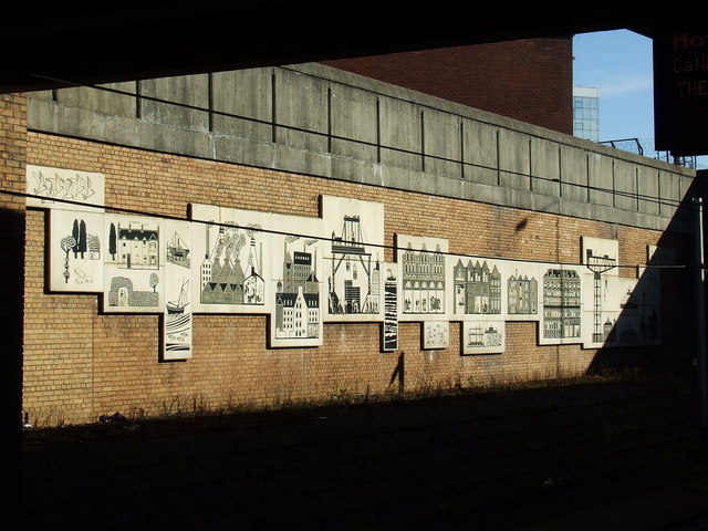 Mural in black and white agains red brick wall of Exhibition Centre 