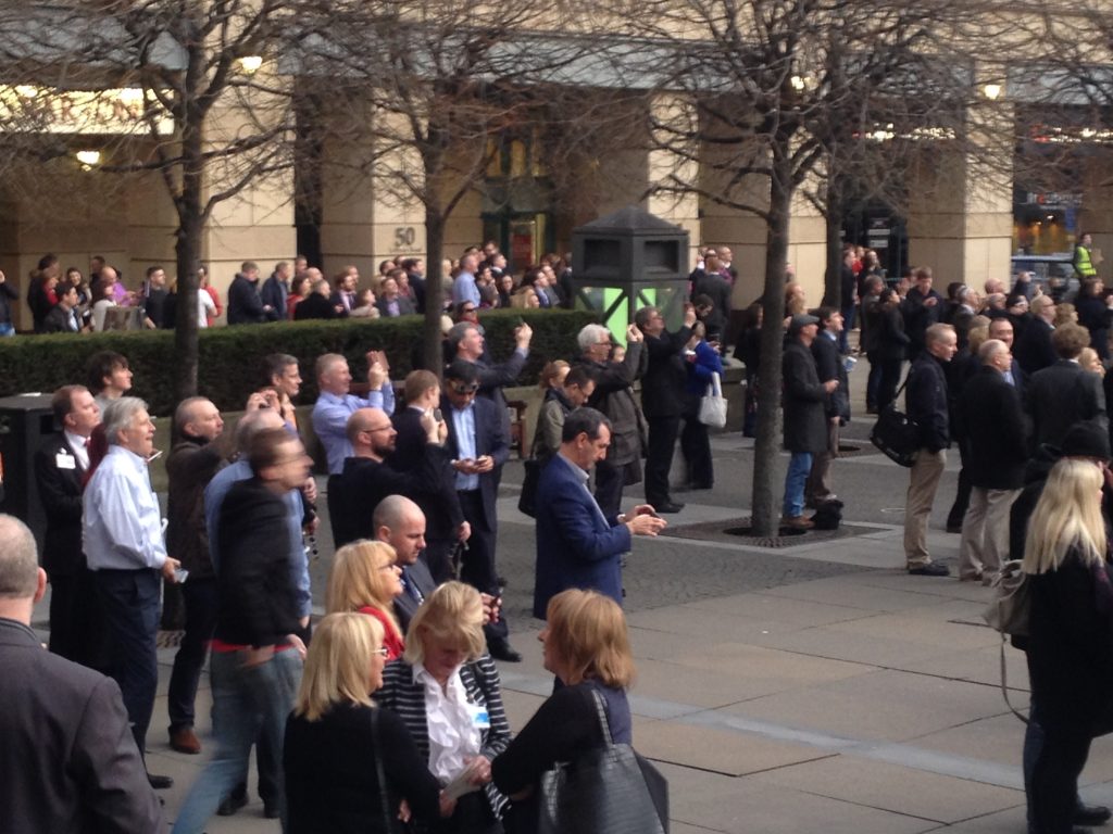 A crowd gathering outside the Sheraton hotel, smartphones at the ready to capture the total eclipse of the sun