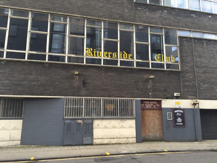 The old Riverside Club sign in the window of what used to be Graphical House