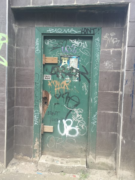 Graffiti-spattered door of 39 Bridge Street