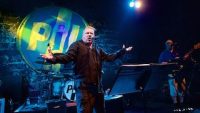 Johnny Rotten (now John Lyden) standing on the Ironworks stage with outstretched arms, in 2016. Photo courtesy Paul Campbell